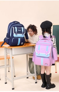 Kids school bags in blue and purple shown in a classroom setting with ergonomic straps