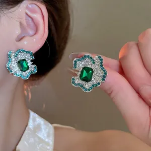 Luxurious emerald-cut green flower stud earrings featuring sparkling crystal petals