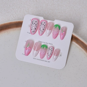 Detail of pink strawberry and fruit 3D press-on nails with glossy resin finish