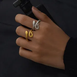 Golden and silver snake wrap rings with scale texture in a stylish open design