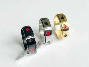 Three-piece set of spinner rings with poker suit patterns in black, gold, and silver finish