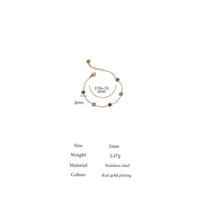 Detailed view of gold plated stainless steel bracelet with six colorful round gemstones