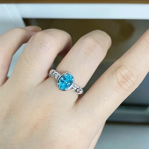 Elegant S925 sterling silver ring with oval neon blue-green gemstone and side diamonds