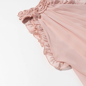 Detailed view of pink chiffon ruffles and elastic stitching on a boho-style garment