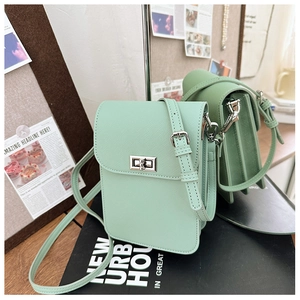 Detail of mint green mini crossbody phone bag with cross-grain leather and silver twist lock