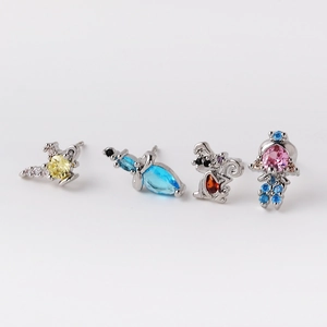 Close-up of four-piece silver stud set featuring dragonfly, butterfly, and squirrel designs