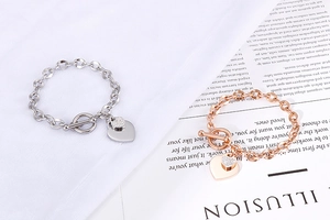 Close-up of double heart pendants on OT buckle chain in silver and rose gold finishes