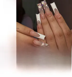Detailed view of French tip extra-long press-on nails with 3D white flowers and rhinestones