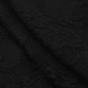 Close-up of the intricate floral lace texture and mesh patterns on the black camisole top