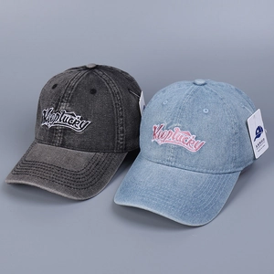 Close-up of distressed denim baseball caps with KeepLucky embroidery in gray and blue
