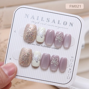 Cat eye press-on nails with purple flower art and champagne glitter in a 10-piece set