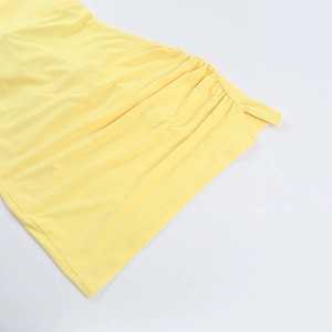 Detail showing the ruched side seam and delicate hemline of this bright yellow dress