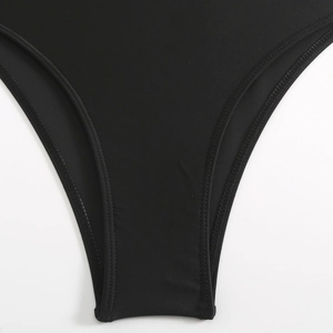 Detail view of black bikini bottom featuring high-elastic fabric and double-needle stitching