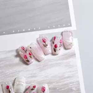 Close-up of jelly nail stickers with hand-painted tulips and 3D pearls on pink gradient base