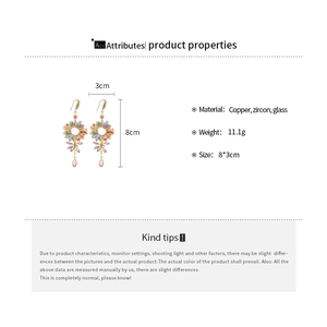 Detailed view of floral tassel earrings with blue zircon crystals and copper beads