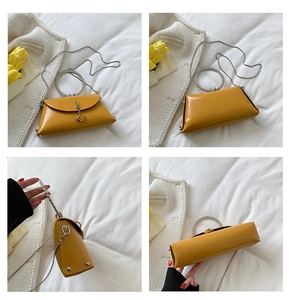 Macro views of yellow leather handbag with diamond-encrusted round handle and gold chain