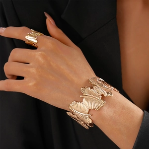 Detailed close-up of golden ginkgo leaf textured open ring and matching cuff bracelet set
