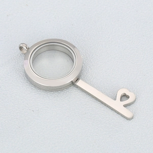 Detailed silver key-shaped photo locket with glass casing and hollow heart pattern
