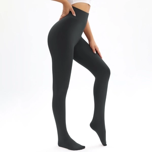 Detail of high-waist black thermal leggings with seamless compression and footed design