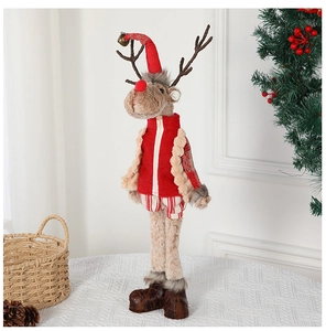 Detailed view of a plush Christmas reindeer figurine with long legs in a cozy festive setting