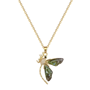 Golden titanium steel dragonfly necklace with sparkling green wings and crystals on white