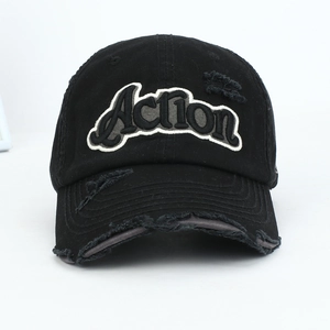 Detail of distressed black baseball cap with Action letter embroidery and ripped effects