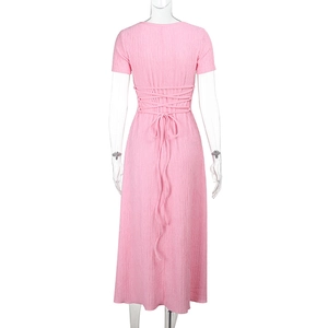 Détail de robe d'été rose en tissu plissé texturé avec laçage croisé au dos raffiné