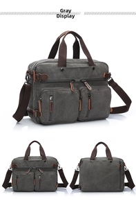 Detail view of large grey canvas business bag showing multi-pocket design and leather pulls