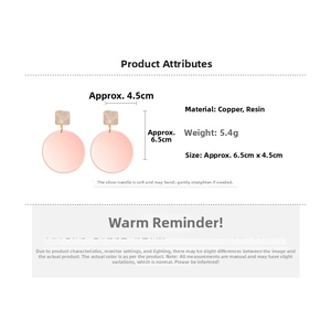 Detail view of pink resin round drop earrings with dimensions 6.5cm by 4.5cm