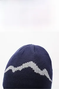 Detail of navy knit beanie showing grey mountain pattern and woven wool texture