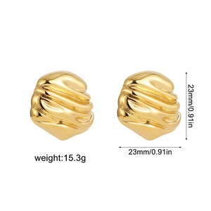 Detailed macro view of 23mm golden crinkled metal stud earrings with mirror finish