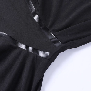 Detail of black sports jumpsuit showing stitching craft and premium fabric texture