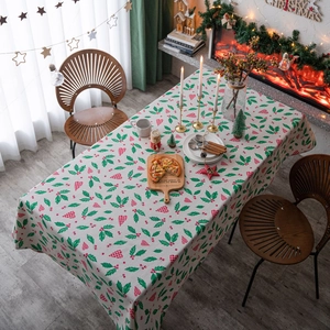 Christmas tablecloth with holly leaves and red heart patterns on cream linen fabric