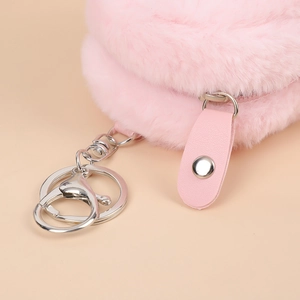 Detailed close-up of pink plush coin purse showing the metal keychain and PU leather zipper pull