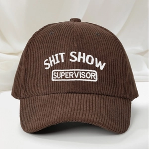 Brown corduroy baseball cap with Shit Show Supervisor white embroidery on silk background