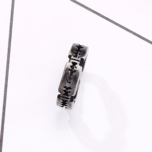 Close-up of vintage punk razor blade ring with antique silver finish and industrial镂空 design