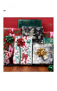 Macro shot of assorted Christmas gift wrapping paper featuring pink bows and green snowflakes