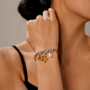 Detail of marine-themed bracelet with starfish charms and a white pearl on the wrist