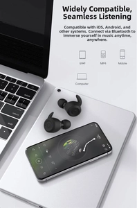 Detail showing black TWS wireless earbuds on a silver tablet and laptop for sport use