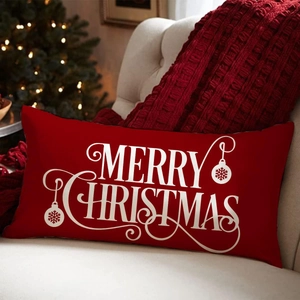 Red Merry Christmas linen pillow cover with festive snowflake prints on a cozy sofa
