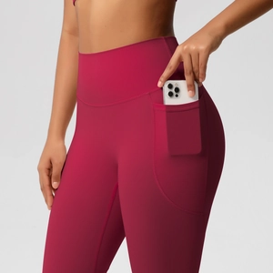 Close-up of deep wine red high-waisted yoga leggings with functional side phone pocket