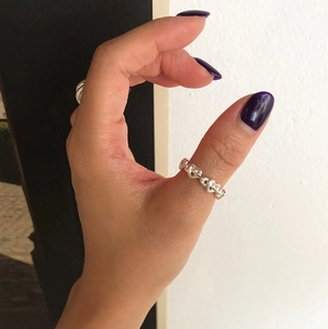 Close-up of minimalist 925 sterling silver chain ring worn on thumb with split background