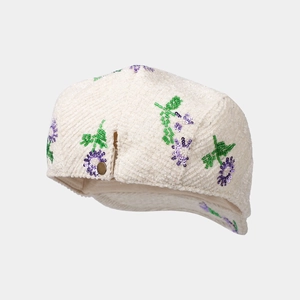 White corduroy newsboy cap featuring elegant purple sequin floral embroidery and gold button