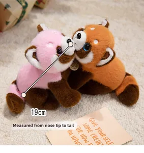 Detail of 19cm plush panda dolls in pink and orange colors with soft faux fur texture