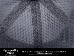 Macro view of grey honeycomb mesh polyester fabric showing breathable texture and stitching