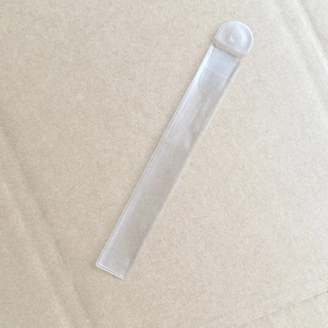 Detail of clear plastic double-ended makeup brush handle with built-in hanging hole