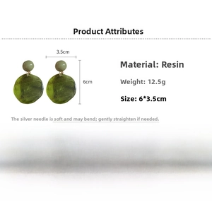 Detail view of green resin earrings with marble texture, measuring 6cm by 3.5cm