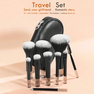 Detail of 10-piece travel makeup brush set with black handles and round leather pouch