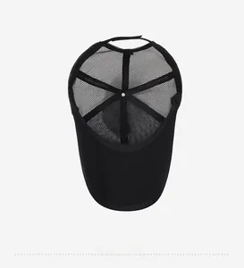 Detail of the breathable mesh interior and adjustable back strap of the black trucker cap
