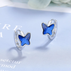 Elegant silver butterfly hoop earrings with deep blue crystals for a stylish look